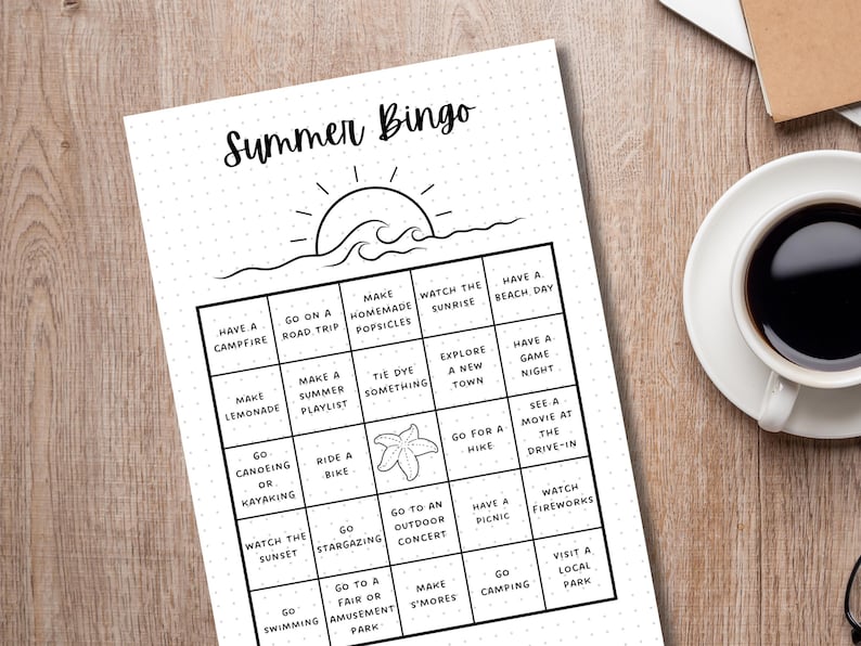 May include: A black and white printable summer bingo card with activities like making lemonade, going on a road trip, and watching fireworks. The card has a sun and waves graphic at the top.