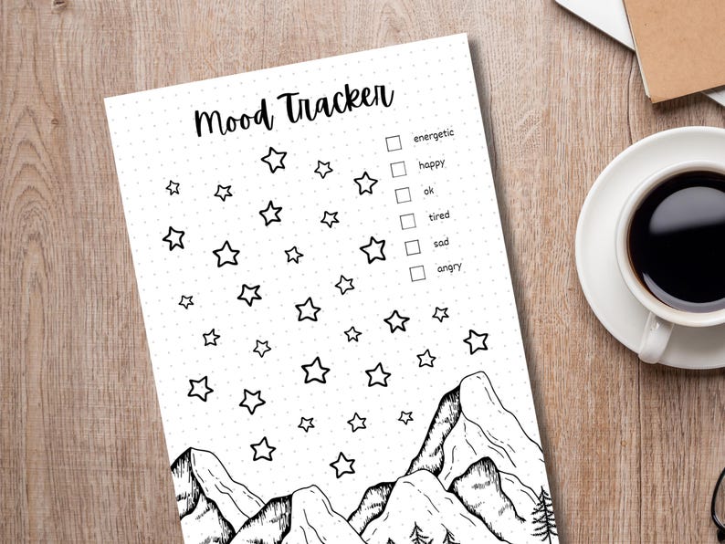 May include: A black and white mood tracker printable featuring a mountain range and stars. The printable includes a checklist with the following options: energetic, happy, ok, tired, sad, angry.