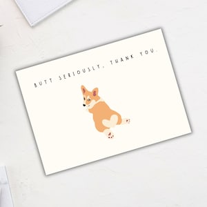 May include: A white card with a cartoon image of a corgi dog with the text "Butt Seriously. Thank You."