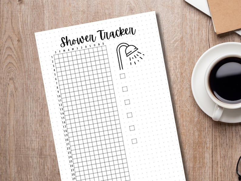May include: A printable shower tracker with a grid for each day of the month and a checklist for tracking showers taken. The tracker has a simple black shower head icon at the top.
