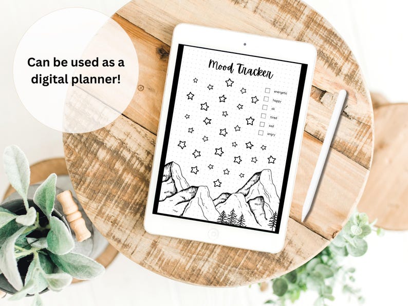 May include: A black and white digital planner featuring a mountain and star design. The planner includes a section for mood tracking with checkboxes for energetic, happy, ok, sad, tired, and angry.