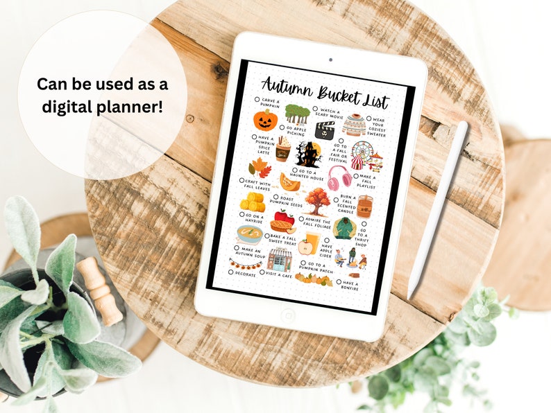 May include: A digital planner on a tablet with a white stylus. The planner is a checklist of autumn activities with illustrations of pumpkins, leaves, and other fall-themed items. The text on the planner reads "Autumn Bucket List".