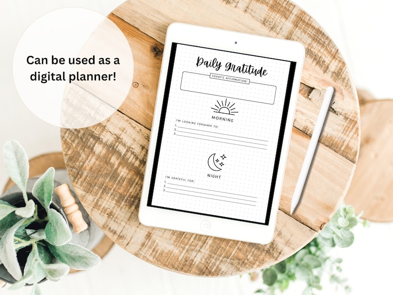May include: A digital planner on a tablet with a white background. The planner has a black and white design with the text "Daily Gratitude" and sections for "Morning" and "Night".