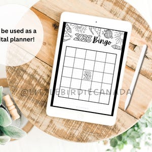 May include: A tablet displaying a 2026 Bingo grid, suitable for digital planning, rests on a wooden surface. A stylus and greenery are also present. The image includes the text "Can be used as a digital planner!"