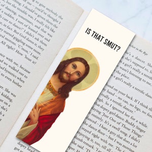 May include: A close-up of a painting of Jesus Christ with a red robe and a crown of thorns. The painting is framed in a white border and has a text overlay that reads "Is That Smut?"