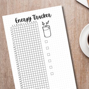 May include: A black and white printable energy tracker with a battery icon and a grid for marking energy levels. The tracker has a dotted background and the text "Energy Tracker" at the top.