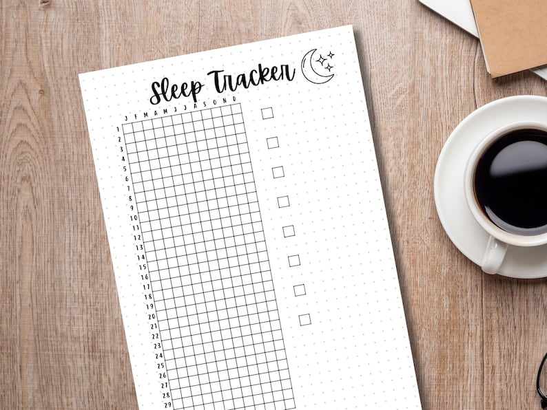 May include: A black and white printable sleep tracker with a grid for each month of the year. The tracker has a moon and stars graphic at the top and the text "Sleep Tracker" in a handwritten font.