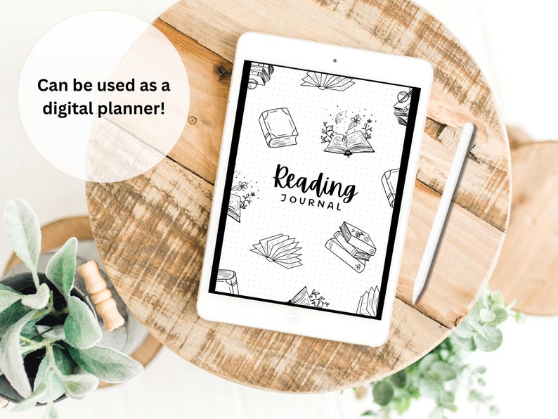 May include: A white tablet with a black and white reading journal template on the screen. The template features a dotted grid background with illustrations of books and the text "Reading Journal".