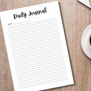 May include: A blank white daily journal with a black title "Daily Journal" and the word "Date:" followed by a blank line for writing the date.