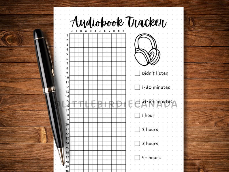 May include: A black pen rests on a white "Audiobook Tracker" sheet. The sheet features a grid for tracking listening habits, with checkboxes for time increments and a headphone graphic. The text includes months of the year.