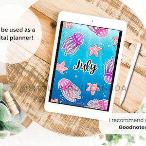 May include: A digital planner displayed on a white tablet, featuring a blue background with jellyfish and starfish illustrations. The word "July" is written in cursive. A stylus rests beside the tablet. Text reads: "Can be used as a digital planner!" and "I recommend using Goodnotes!"