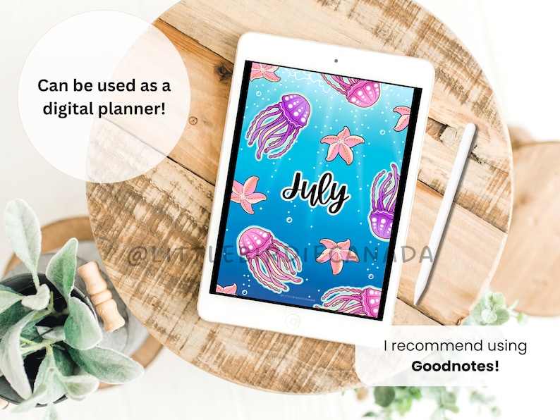 May include: A digital planner displayed on a white tablet, featuring a blue background with jellyfish and starfish illustrations. The word "July" is written in cursive. A stylus rests beside the tablet. Text reads: "Can be used as a digital planner!" and "I recommend using Goodnotes!"