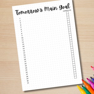 May include: A printable daily planner page with a dotted grid and a section for a main goal. The page is labelled "Tomorrow's Main Goal" and has a check box for "Complete". The page is numbered 1-31.