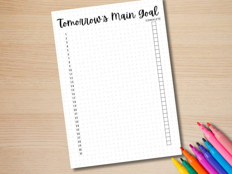 May include: A printable daily planner page with a dotted grid and a section for a main goal. The page is labelled "Tomorrow's Main Goal" and has a check box for "Complete". The page is numbered 1-31.