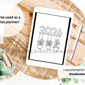 May include: A digital planner displayed on a white tablet. The planner features the year 2026 above three hanging flower pots. The text "Can be used as a digital planner!" and "I recommend using Goodnotes!" are also visible.