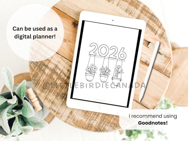 May include: A digital planner displayed on a white tablet. The planner features the year 2026 above three hanging flower pots. The text "Can be used as a digital planner!" and "I recommend using Goodnotes!" are also visible.