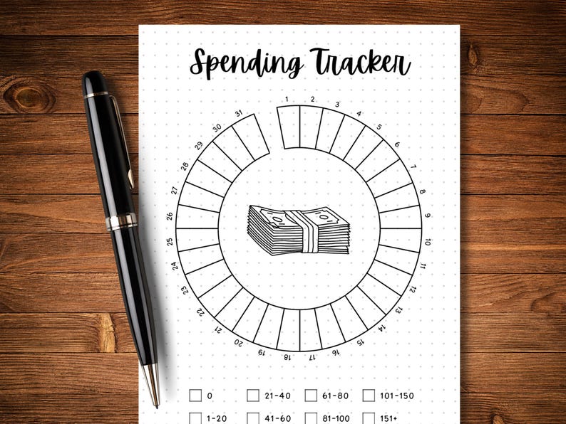 May include: A black and white printable spending tracker with a circle divided into 31 sections. The sections are numbered 1 through 31. The centre of the circle features a stack of money with a rubber band around it. The text "Spending Tracker" is at the top of the page. Below the circle are boxes for tracking spending amounts: 0, 1-20, 21-40, 41-60, 61-80, 81-100, 101-150, and 151+.