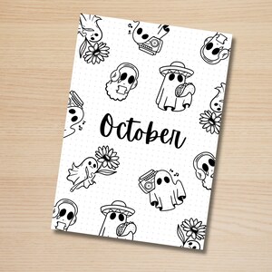 May include: A black and white printable planner page with a dotted background and a repeating pattern of ghosts, flowers, and cassette tapes. The text "October" is written in the center of the page.