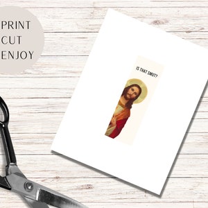 May include: A white card with the text "IS THAT SMUT?" printed on it. A picture of Jesus is peeking out from behind the card.