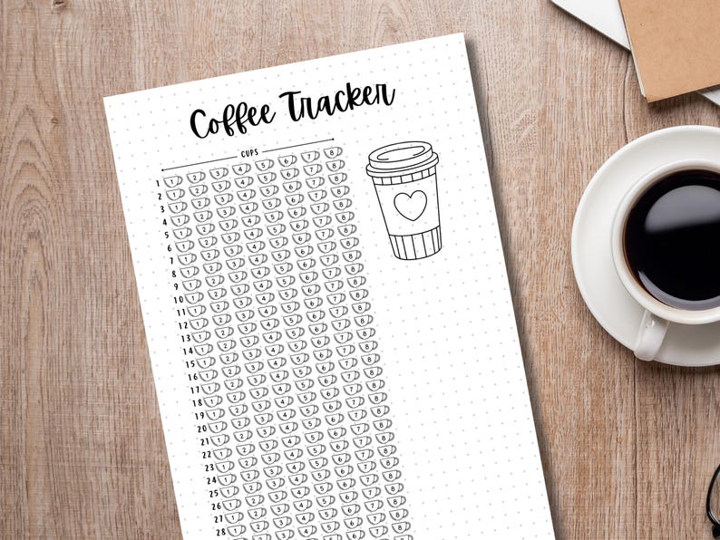 May include: A printable coffee tracker with a black and white design. The tracker has a list of numbers from 1 to 27, with a row of coffee cups next to each number. The tracker also has a black and white illustration of a coffee cup with a heart on it.