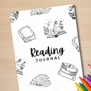 May include: A black and white printable reading journal cover with the text "Reading Journal" and illustrations of books, flowers, and leaves.