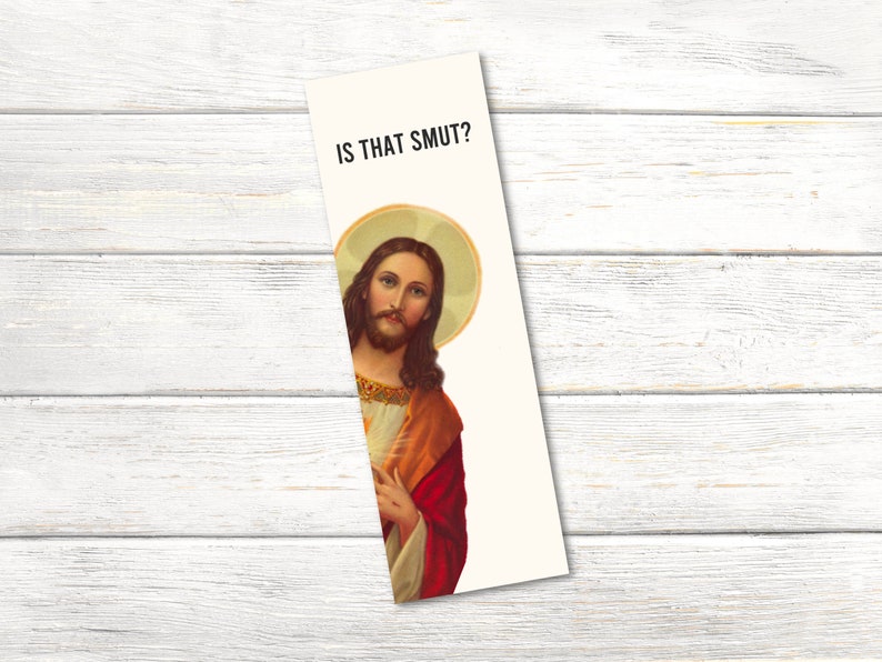 May include: A white bookmark with a picture of Jesus Christ and the text "IS THAT SMUT?" printed on it.