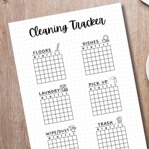 May include: A printable cleaning tracker checklist with a black and white design. The checklist includes tasks such as floors, dishes, laundry, pick up, wipe/dust, and trash. Each task has a corresponding icon and a grid for marking off days of the week.