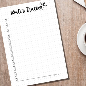 May include: A white printable water tracker with a black dotted grid and the text "Water Tracker" at the top.