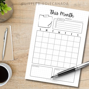 May include: A printable monthly calendar planner with a dotted background. The calendar has sections for goals, birthdays, and events. The text "This Month" is at the top of the page.