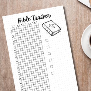May include: A printable Bible tracker with a grid for each month of the year and a checklist for daily reading. The image includes a drawing of a closed Bible with a cross on the cover.