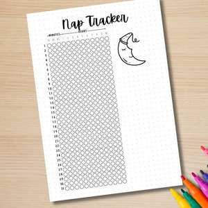 May include: A white Nap Tracker sheet with a dotted grid and a cartoon moon illustration. The sheet includes columns for hours and rows for minutes, with a space to track naps. Colorful markers are visible in the corner.