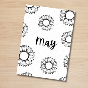 May include: A white printable planner page with a black and white sunflower pattern and the word "May" in black cursive writing.