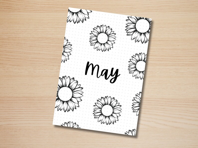 May include: A white printable planner page with a black and white sunflower pattern and the word "May" in black cursive writing.