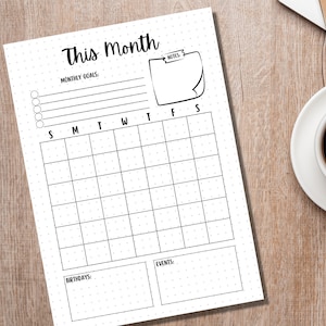 May include: A printable monthly planner with a dotted background. The planner includes sections for monthly goals, birthdays, events, and notes. The days of the week are labeled S, M, T, W, T, F, S.