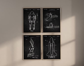 May include: Set of four black and white vintage space patent prints. The prints feature a spacesuit, a space station, a satellite, and a space shuttle. Each print has a black background and white text and illustrations.