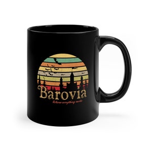 May include: Black ceramic mug featuring a retro sunset design with the word "Barovia" in a vintage font. The design includes bats, a castle silhouette, and the phrase "Where everything sucks."