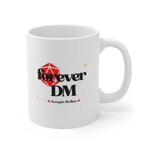 May include: White ceramic mug with the text "forever DM" in black and a red geometric shape. Below the text is "Accepts Bribes" in black. The mug has a curved handle and is designed for hot beverages.