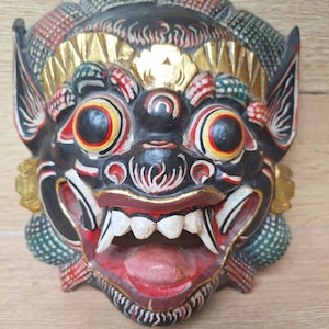 Balinese Barong mask in carved wood, Indonesia, traditional hand-carved crafts. Bali