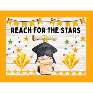 May include: A graduation themed gnome with a black cap and gown holding a diploma that says "Graduate". The gnome is standing in front of a white wood background with yellow stars and the text "Reach for the Stars".