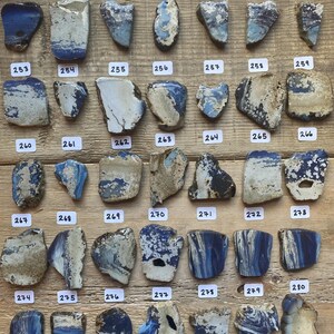 May include: A collection of 24 blue and white ceramic tiles with numbers 246 through 280 printed on each tile.