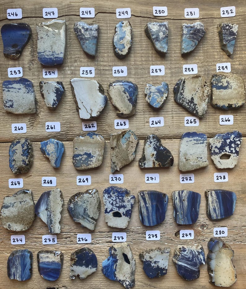 May include: A collection of 24 blue and white ceramic tiles with numbers 246 through 280 printed on each tile.
