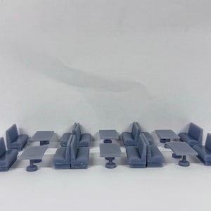 May include: A set of 10 miniature grey plastic booths and tables, ideal for creating a miniature diner or restaurant scene.