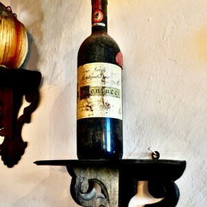 wine bottle mounted on shelf, winery, Tuscan wines,collectable wines,world class reds,Montepulciano,Chianti Classico,Sangiovese,Petit Verdot