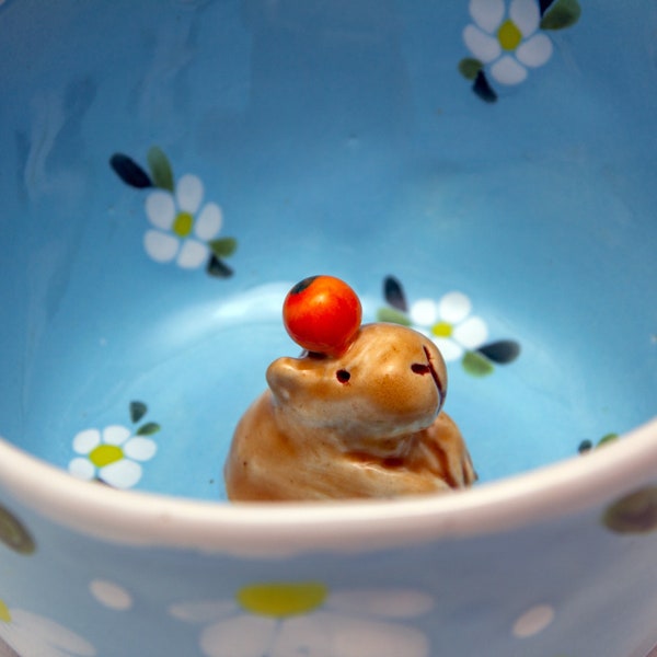 Colorful Blue Ceramic Mug with Artistic Flower Pattern and Adorable Capybara Inside