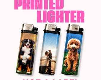 May include: Three rectangular lighters with black tops and metal ignition mechanisms. The left lighter features a Bernese Mountain Dog, the center shows a couple in a wedding setting, and the right displays a golden-brown dog. Text reads PRINTED LIGHTER NOT A LABEL.