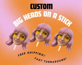 May include: Three custom big heads on a stick, with pink hair and yellow sunglasses. The text "CUSTOM BIG HEADS ON A STICK" is at the top of the image. The text "FREE SHIPPING! FAST TURNAROUND!" is at the bottom of the image.