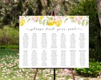 May include: A white wedding seating chart on a wooden easel, decorated with watercolor lemons and pink flowers. The text "please find your seat" is above the guest names, organized by table number.