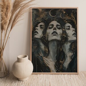 May include: A framed print of a digital painting featuring three women with dark hair and eyes, looking up at the viewer. The background is a dark blue with gold accents and crescent moons.