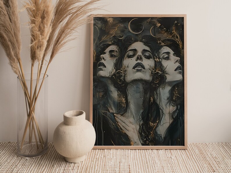May include: A framed print of a digital painting featuring three women with dark hair and eyes, looking up at the viewer. The background is a dark blue with gold accents and crescent moons.
