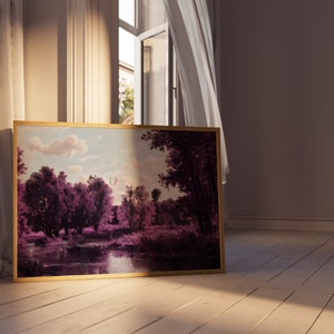 May include: A framed landscape painting with a gold frame. The painting depicts a river scene with trees and a cloudy sky. The colors are muted and the scene is peaceful.